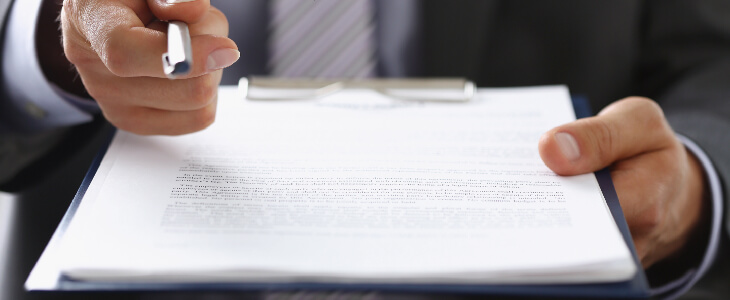 A business law lawyer holding a clipboard