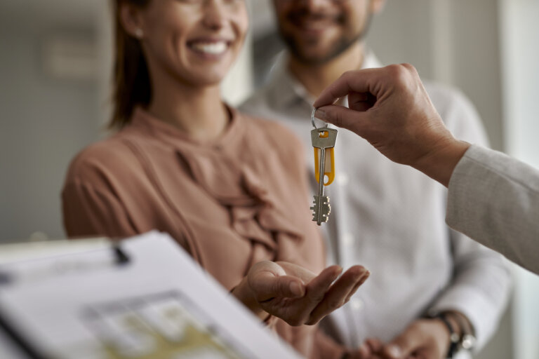 couple receiving keys to real estate property