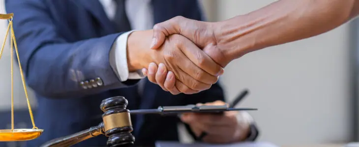 Lawyer who provides legal advice in the office. Businessman and lawyer shaking hands.