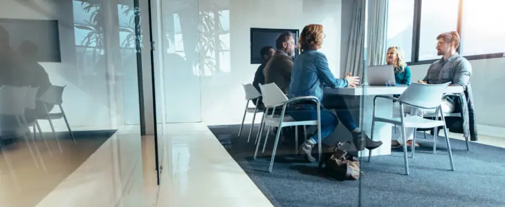 Group of business people sitting in a conference room, discussing and brainstorming over a new project. Creative team of professionals is collaborating on innovative ideas for their company's success.